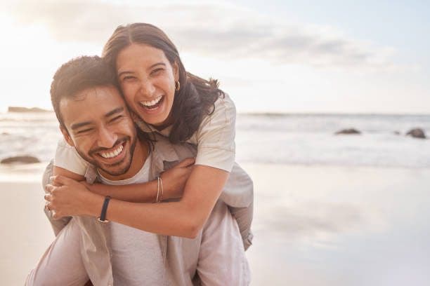 A couple outdoors together, laughing