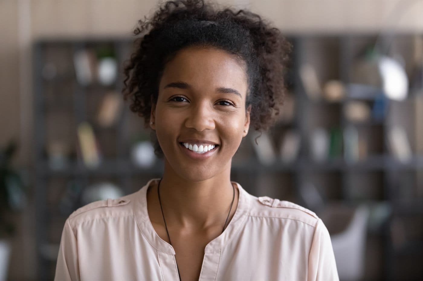 A woman smiling during an online counseling session